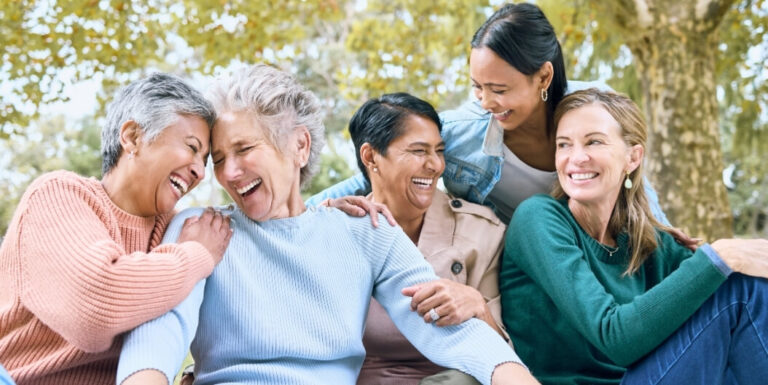 Group of Elderly Women Laughing Together Outdoors at an Independent Living Facility