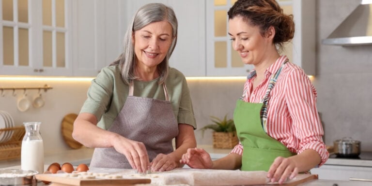 Elderly Woman Baking Cookies with a Friend in the Kitchen at Independent Living Facility